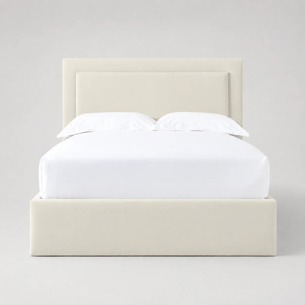 Cream upholstered bed frame with white linens, modern luxury bedroom furniture