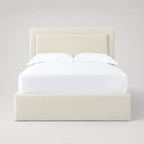 Cream upholstered bed frame with white linens, modern luxury bedroom furniture