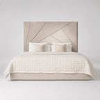Luxury beige upholstered bed with geometric headboard, quilted duvet, and accent pillows for modern bedroom