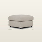 Beige fabric ottoman with black legs, perfect for luxury living room seating and comfort.