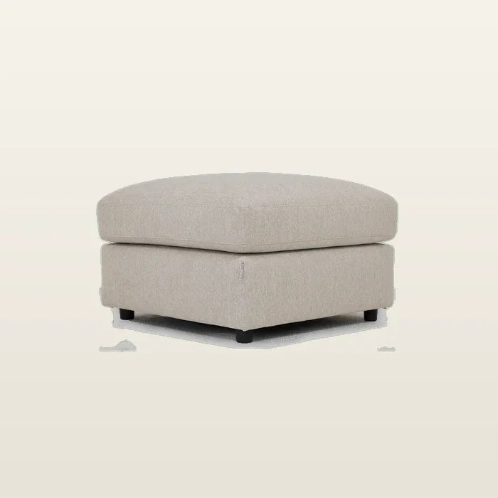 Beige fabric ottoman with black legs, perfect for luxury living room seating and comfort.