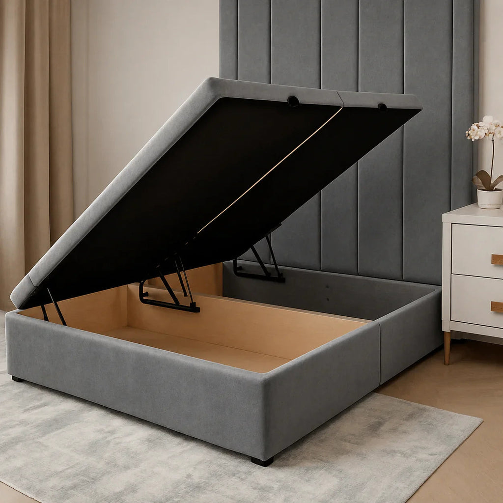Grey upholstered storage bed with lift-up mechanism, showing spacious wooden interior, ideal for luxury bedrooms.