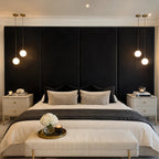Luxury bed with black velvet headboard, modern pendant lights, and elegant bedroom decor
