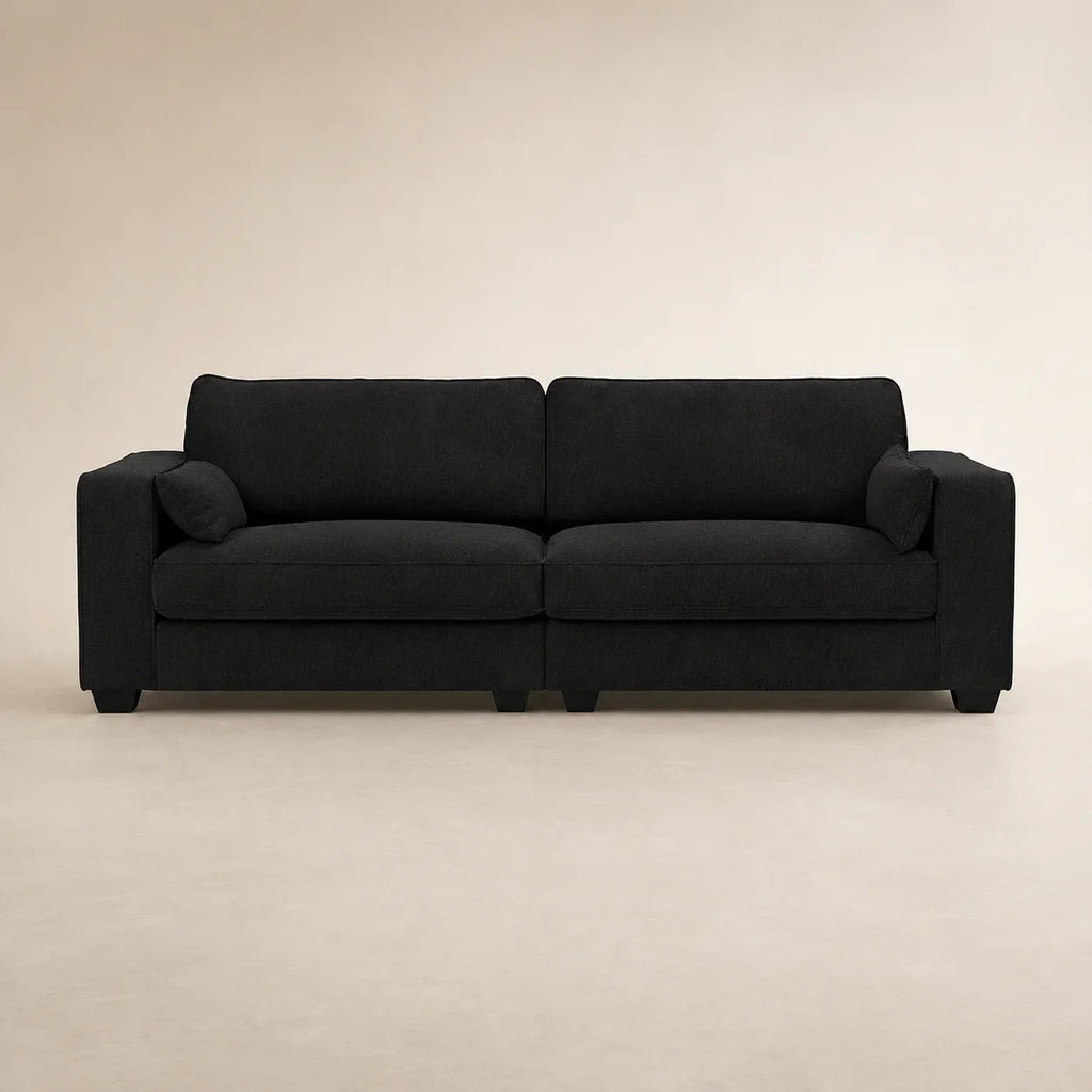 Black fabric sofa with two cushions and matching pillows, modern living room furniture