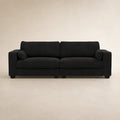 Black fabric sofa with two cushions and matching pillows, modern living room furniture