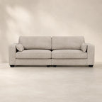 Luxury beige fabric sofa with plush cushions and black legs, ideal for modern living rooms