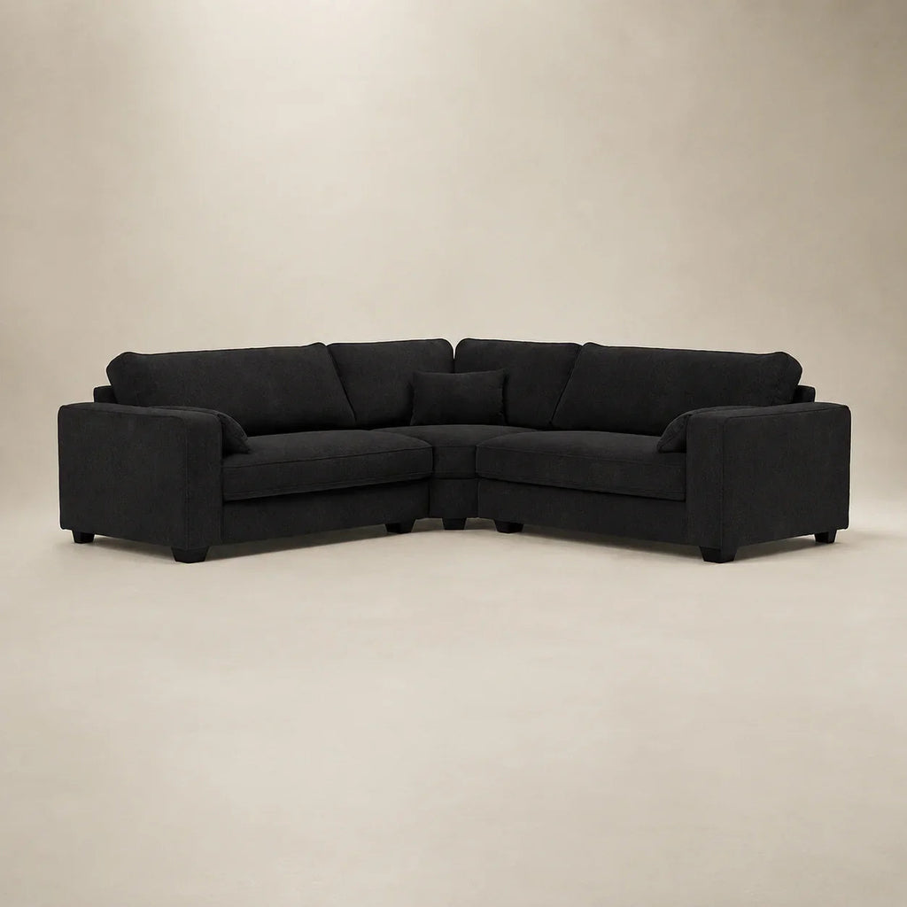 Black fabric corner sofa with plush cushions, modern design for luxury living rooms