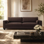 Luxury dark brown fabric sofa in elegant living room with marble coffee table and natural light
