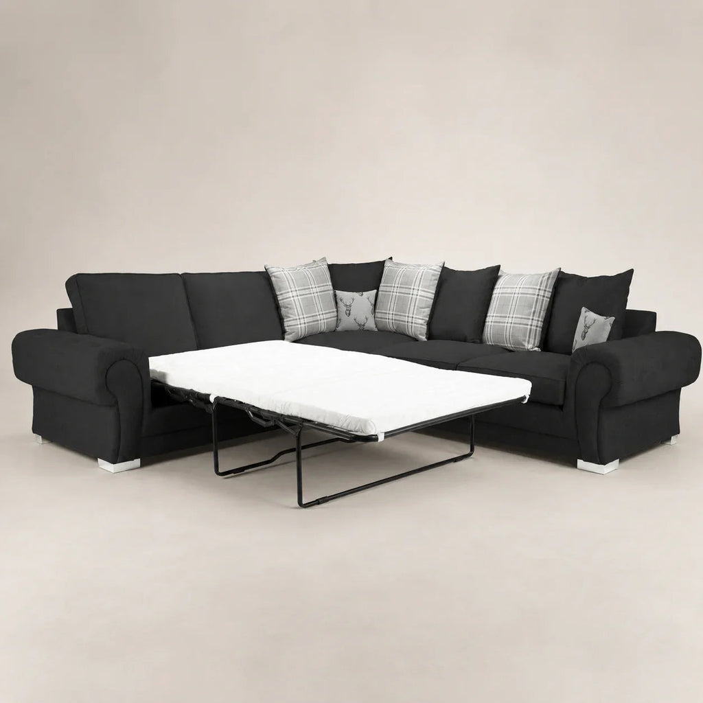 Black sectional sofa with pull-out bed and plaid pillows, luxury living room furniture