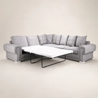 Grey L-shaped sofa bed with pull-out mattress, plaid and stag print cushions, luxury living room furniture