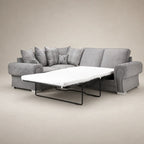 Grey fabric sofa bed with pull-out mattress and plaid cushions, ideal for living room comfort.